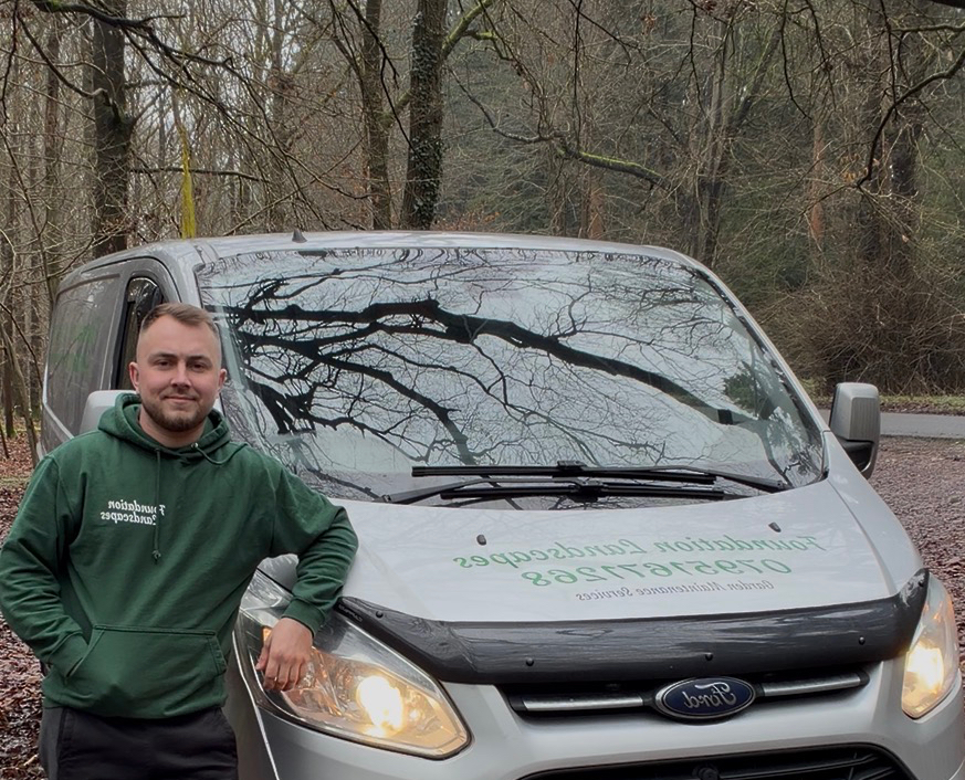 Craig, owner of Foundation Garden and Trees, standing beside his work van